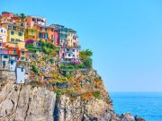 Small italian town with colorful buildings on the rock by the sea, Manarola, Cinque Terre, Italy. Copyspace composition